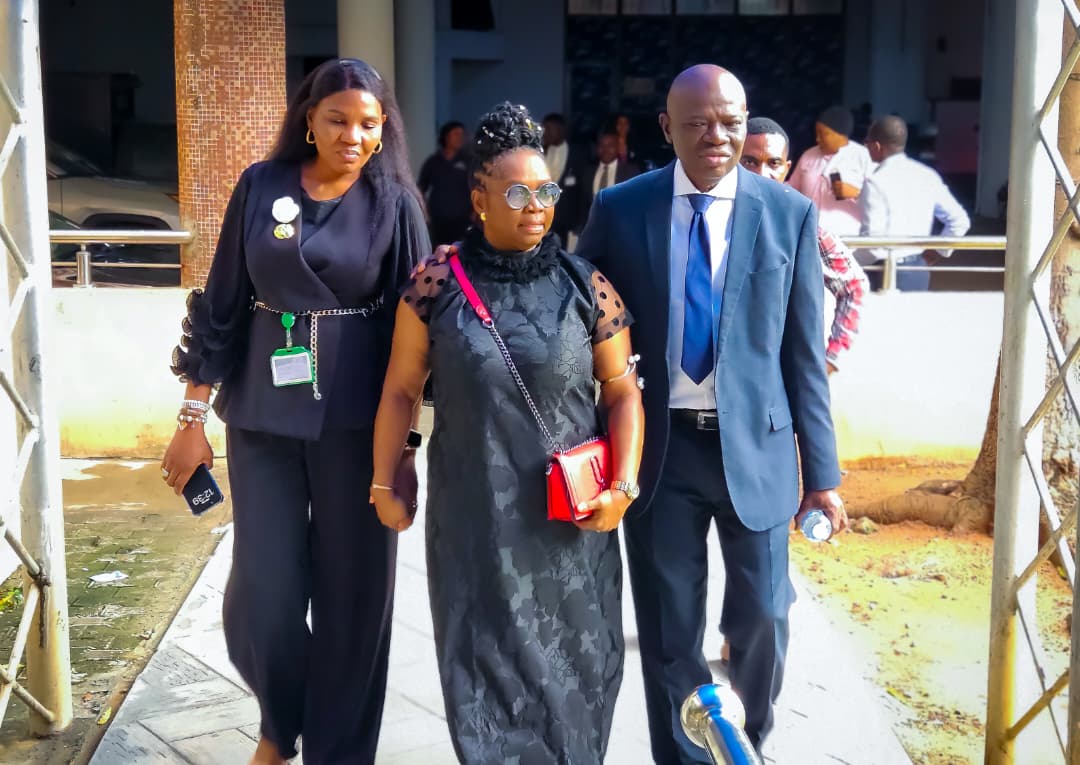 Dr. Oby Nwokedi walking into a building flanked by two colleagues