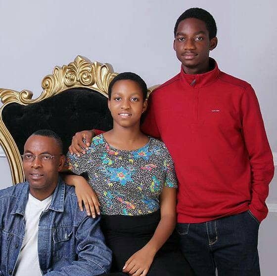 Her husband seated in a gilt chair with their daughter and son standing beside him