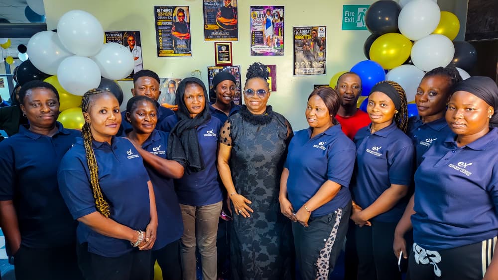 Dr. Oby Nwokedi at the centre of the bank's cleaning team, in matching navy polos